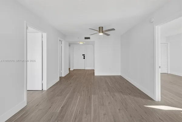 a view of empty room with wooden floor