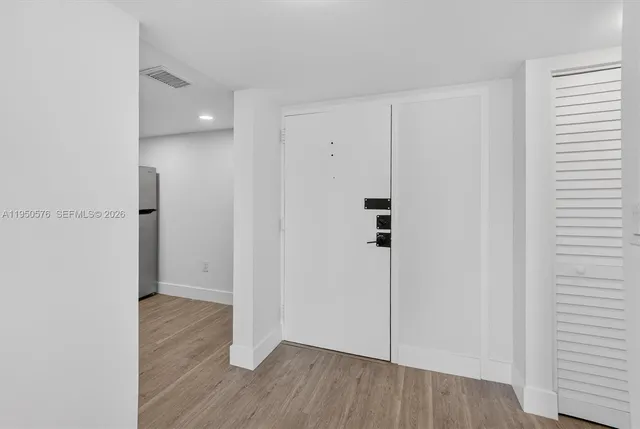 a view of a hallway with wooden floor