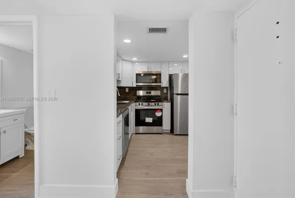 a view of a kitchen from the hallway