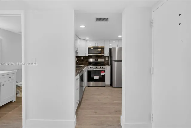 a view of a kitchen from the hallway