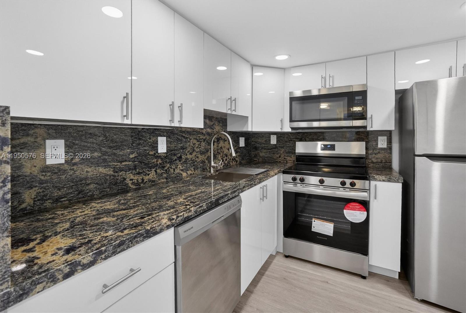 2075 Southwest 122nd Avenue, Unit 531 Miami, FL 33175 - Photo 8 of 27 a kitchen with stainless steel appliances granite countertop a stove a refrigerator and a microwave