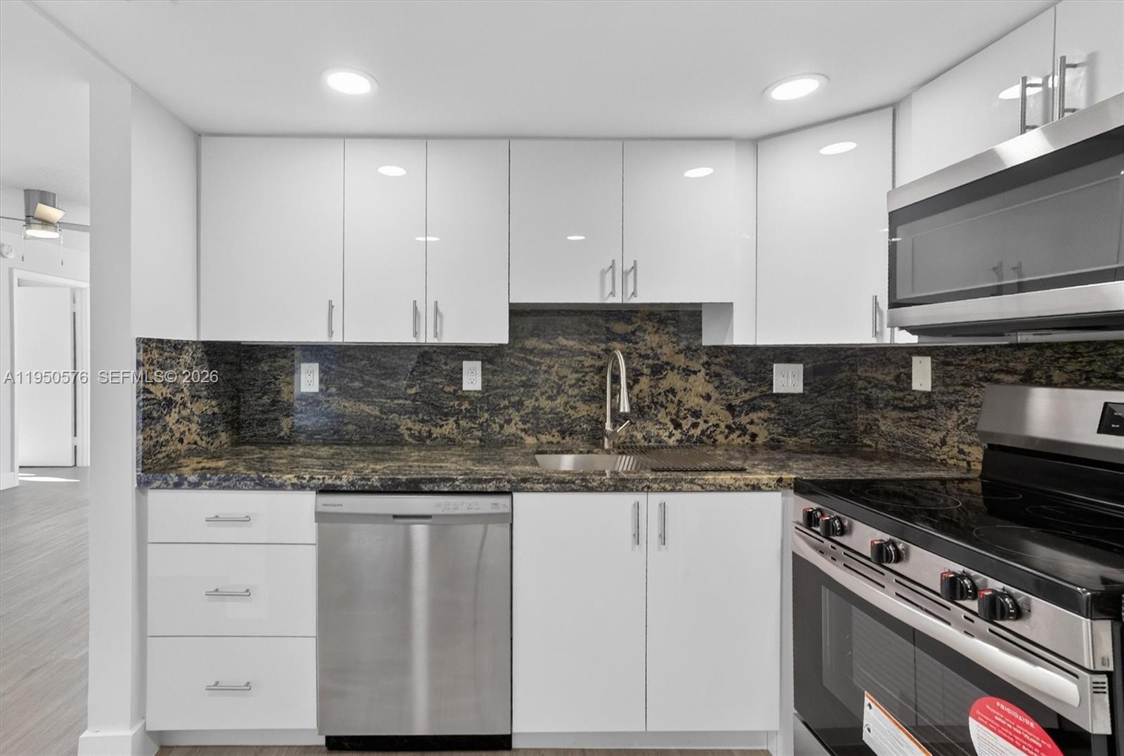 2075 Southwest 122nd Avenue, Unit 531 Miami, FL 33175 - Photo 10 of 27 a kitchen with granite countertop white cabinets and stainless steel appliances