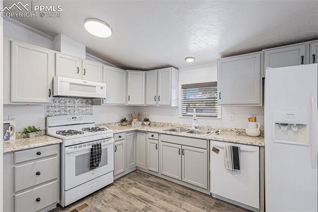 8440 Piute Road Colorado Springs, CO 80926 - Photo 13 of 34 The kitchen is roomy and functional, featuring a pantry, gas range, and abundant cabinets, providing plenty of space for preparing gourmet meals and hosting friends and family.