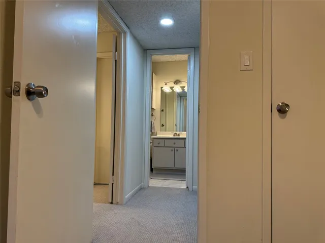 a view of a hallway with a dining room