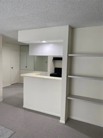 a view of kitchen with cabinets