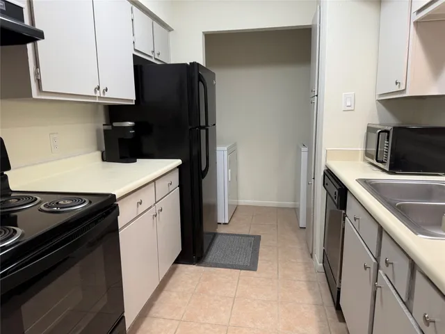 a kitchen with a sink stove and refrigerator