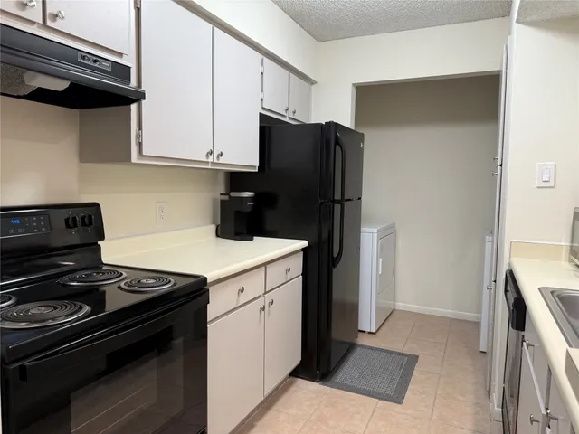 a kitchen with a stove and a refrigerator