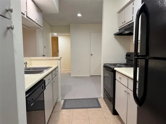a kitchen with a sink stove and refrigerator