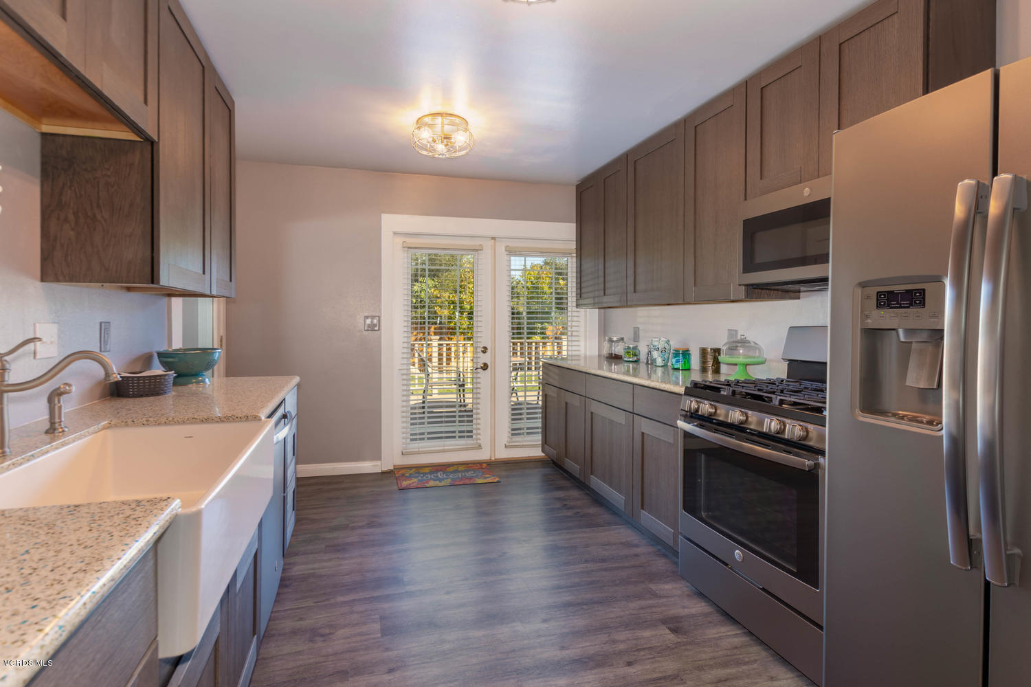 919 Laurel Road Santa Paula, CA 93060 - Photo 3 of 21 a kitchen with stainless steel appliances granite countertop a refrigerator a sink dishwasher a stove and a oven with wooden floor
