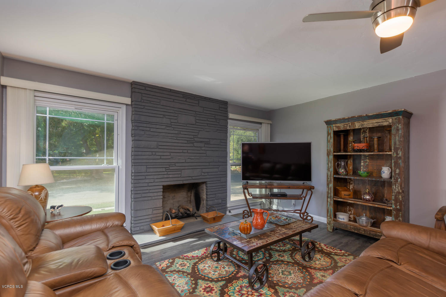 919 Laurel Road Santa Paula, CA 93060 - Photo 5 of 21 a living room with furniture a flat screen tv and a fireplace