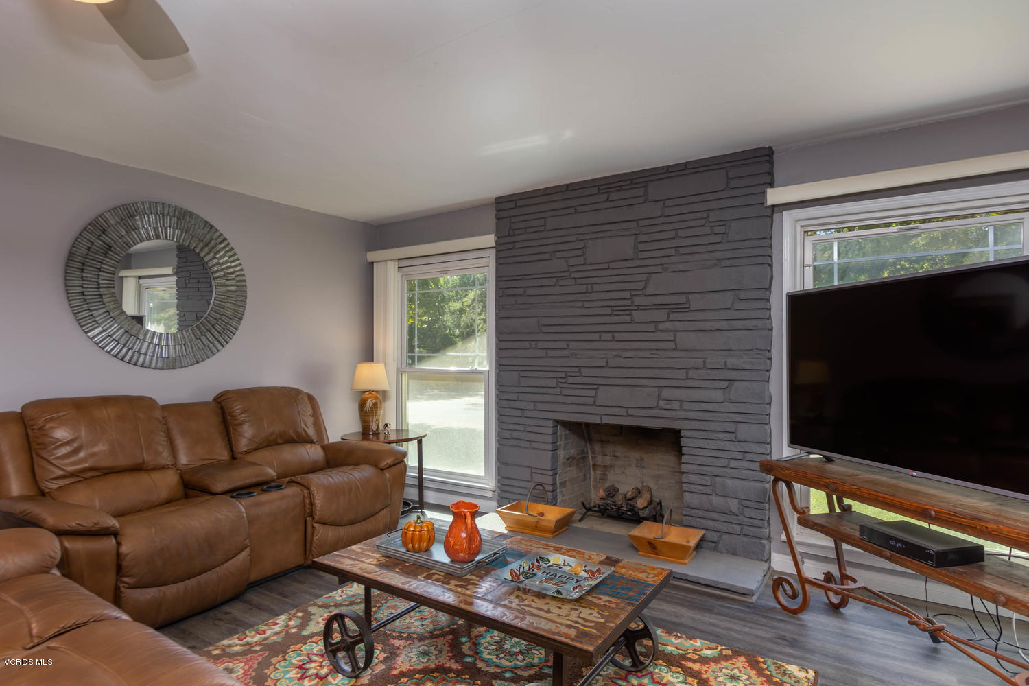 919 Laurel Road Santa Paula, CA 93060 - Photo 7 of 21 a living room with furniture a flat screen tv and a fireplace