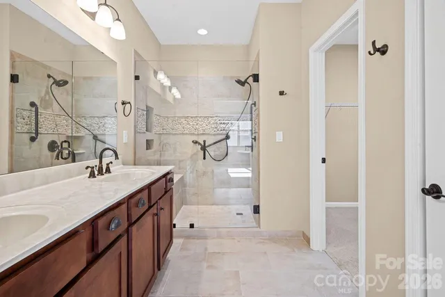 a spacious bathroom with a double vanity sink mirror double and shower