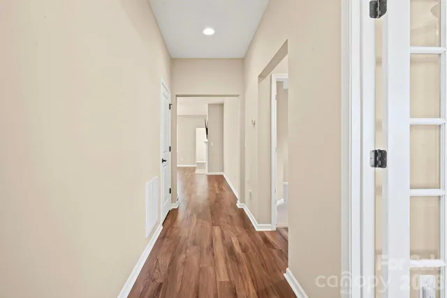 a view of a hallway with wooden floor