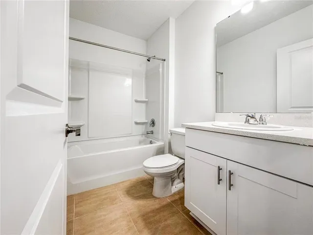a bathroom with a sink toilet vanity and shower