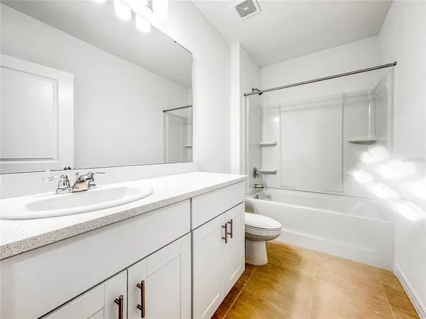 a bathroom with a double vanity sink toilet and shower