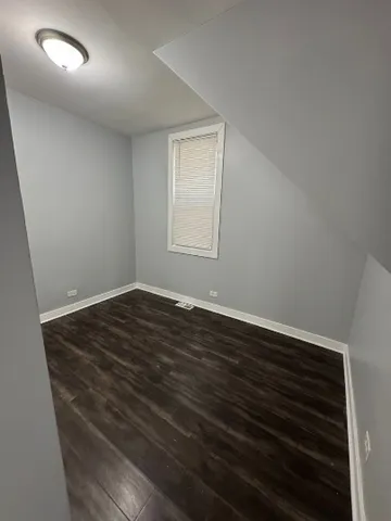 an empty room with wooden floor