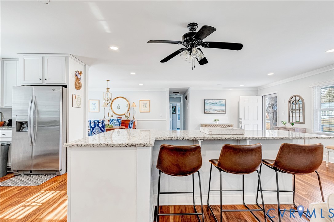 202 Bruce Road Tappahannock, VA 22560 - Photo 11 of 36 a kitchen with stainless steel appliances kitchen island granite countertop a table and chairs
