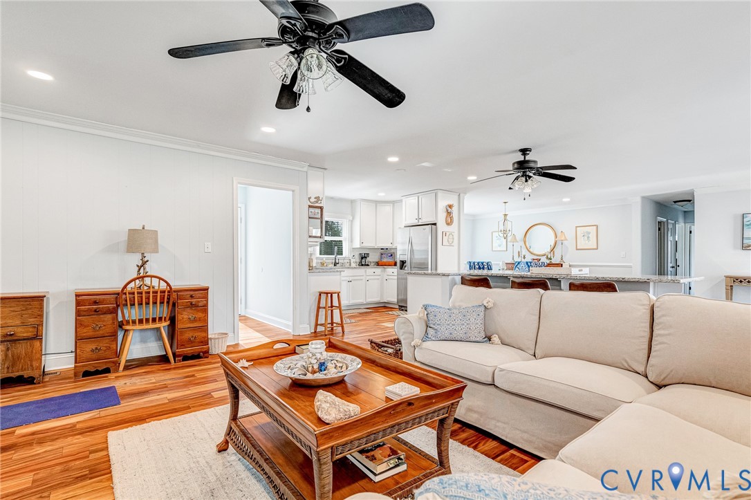 202 Bruce Road Tappahannock, VA 22560 - Photo 18 of 36 a living room with furniture kitchen view and a wooden floor