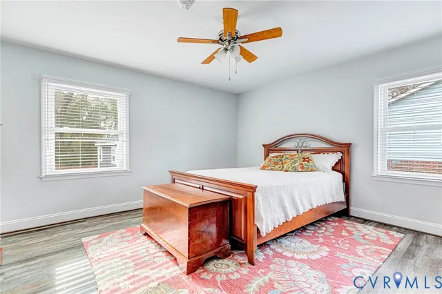 a bedroom with a bed and a mirror on the dresser