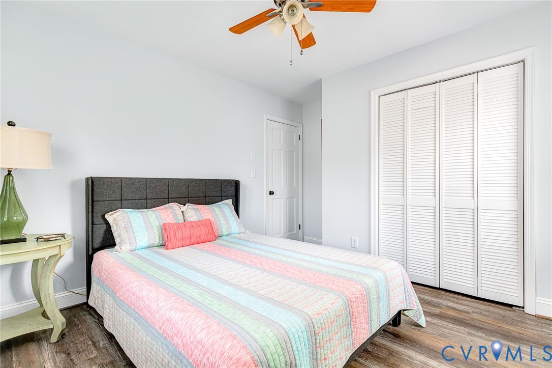 202 Bruce Road Tappahannock, VA 22560 - Photo 27 of 36 a bedroom with a bed and wooden floor