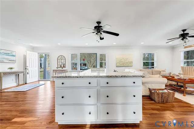 a open kitchen with dining table chairs and wooden floor