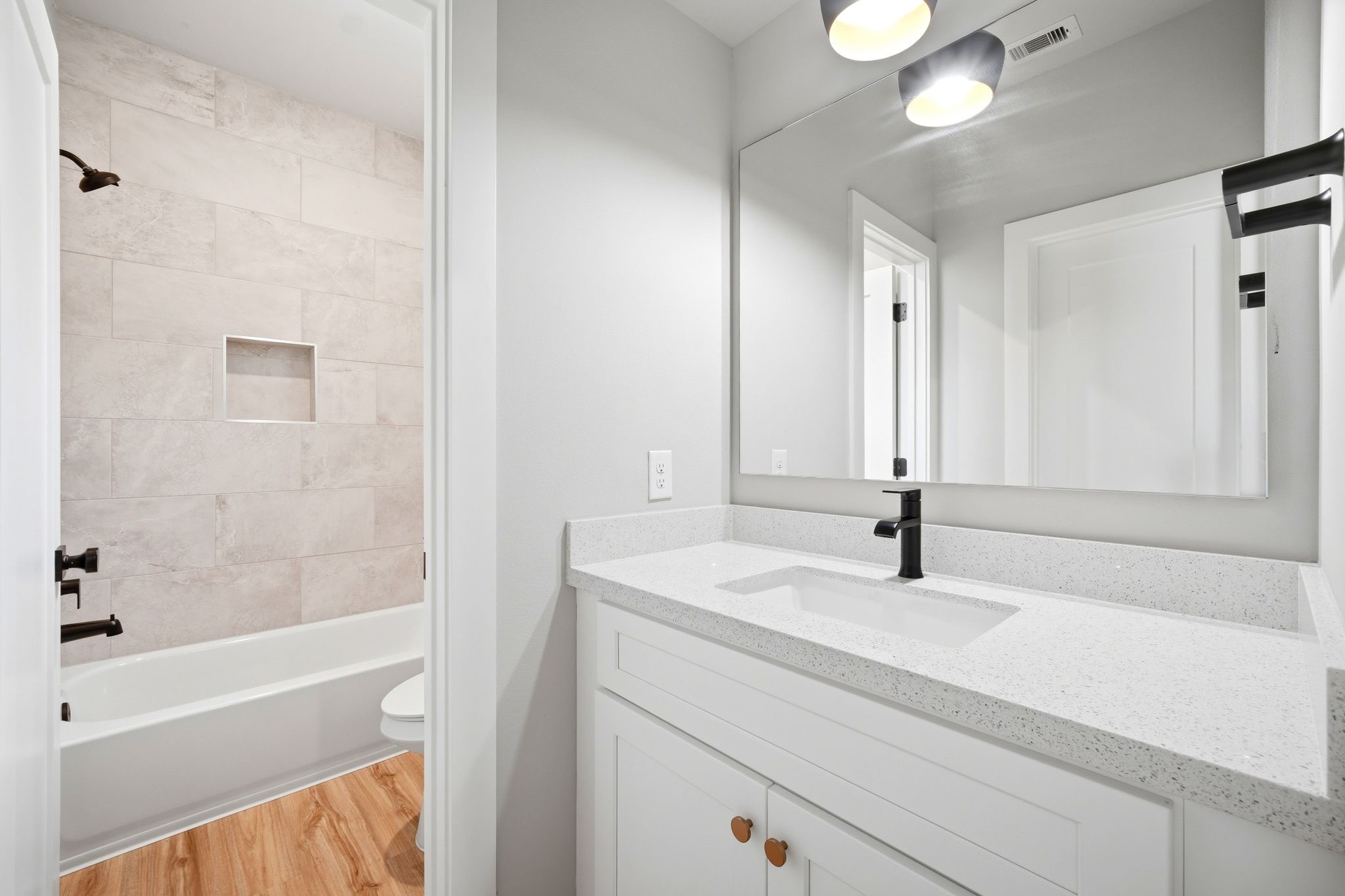 5814 Cebra Street Houston, TX 77091 - Photo 25 of 32 Full secondary bathroom featuring tiled tub/shower combo and modern finishes. Convenient Jack & Jill layout serving secondary bedrooms.