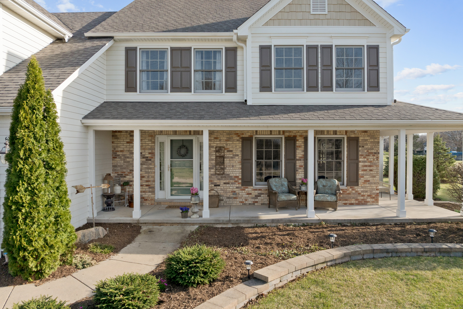 375 Meadow View Burlington, IL 60109 - Photo 2 of 9 a front view of a house with garden
