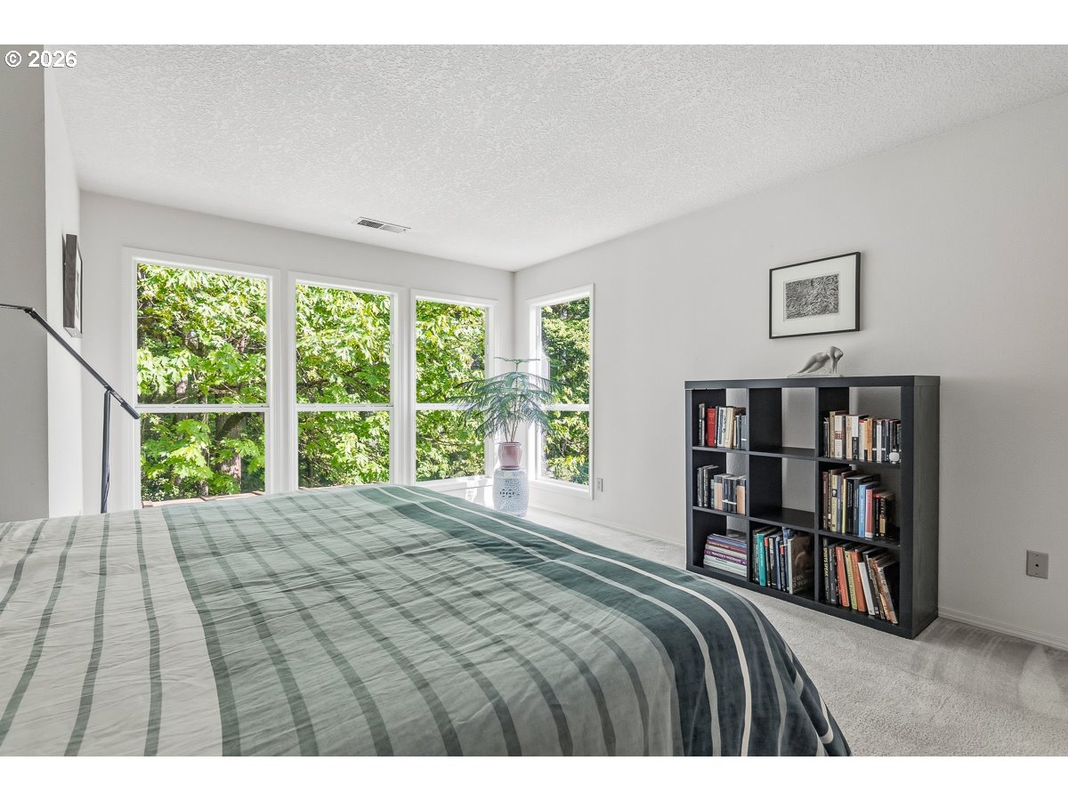 9675 Southwest 163rd Avenue Beaverton, OR 97007 - Photo 13 of 26 a bedroom with a bed a large window and a book shelf