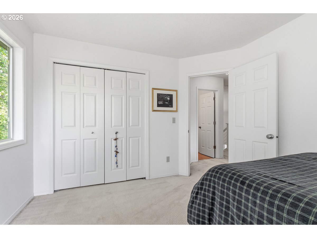 9675 Southwest 163rd Avenue Beaverton, OR 97007 - Photo 19 of 26 a bedroom with a bed and a window