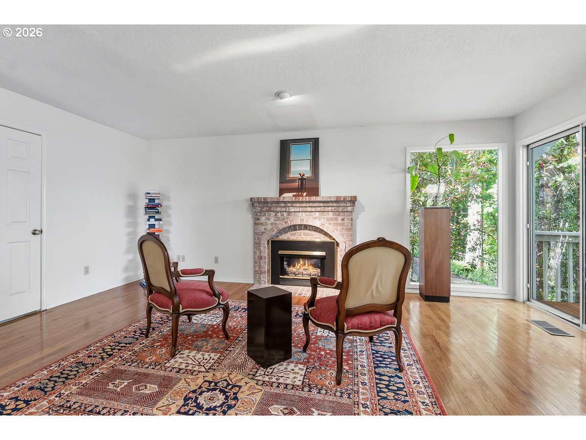 9675 Southwest 163rd Avenue Beaverton, OR 97007 - Photo 8 of 26 a living room with furniture and a fireplace
