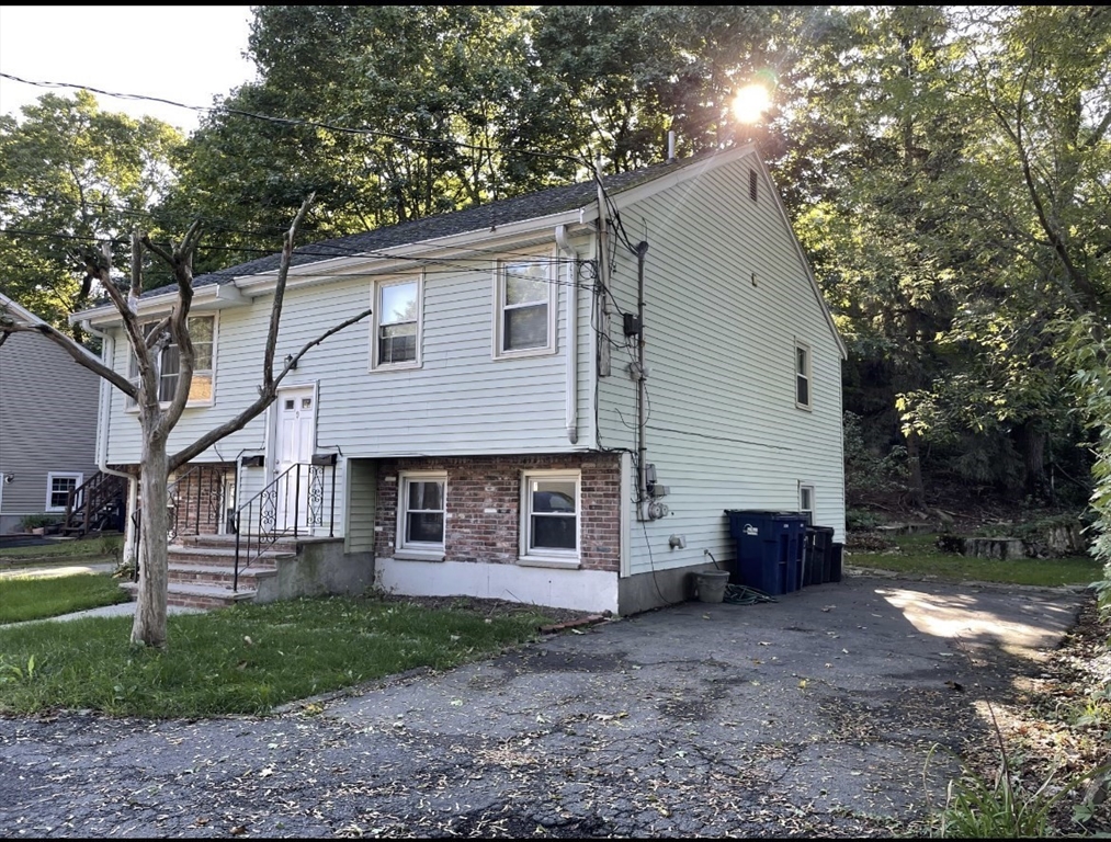 9 Grove Terrace, Unit 2 Boston, MA 02132 - Photo 1 of 8 a view of a house with a yard