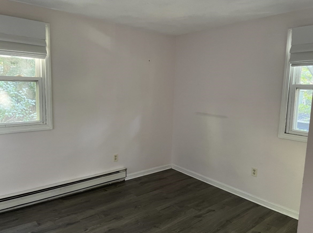 9 Grove Terrace, Unit 2 Boston, MA 02132 - Photo 3 of 8 an empty room with wooden floor and windows