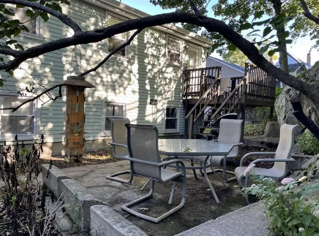 a view of backyard with sitting area