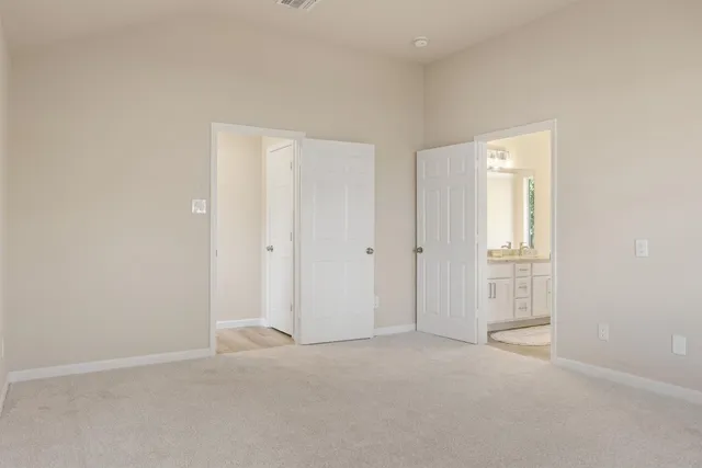 an empty room with windows and closet