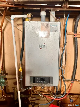 a room with water heater and wooden floor