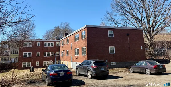 a car parked in front of a brick building