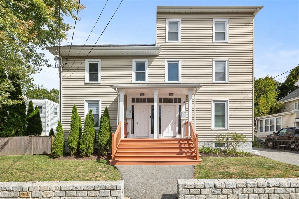 25 Clark Street, Unit 2 Somerville, MA 02143 - Photo 19 of 20 a front view of a house with a yard