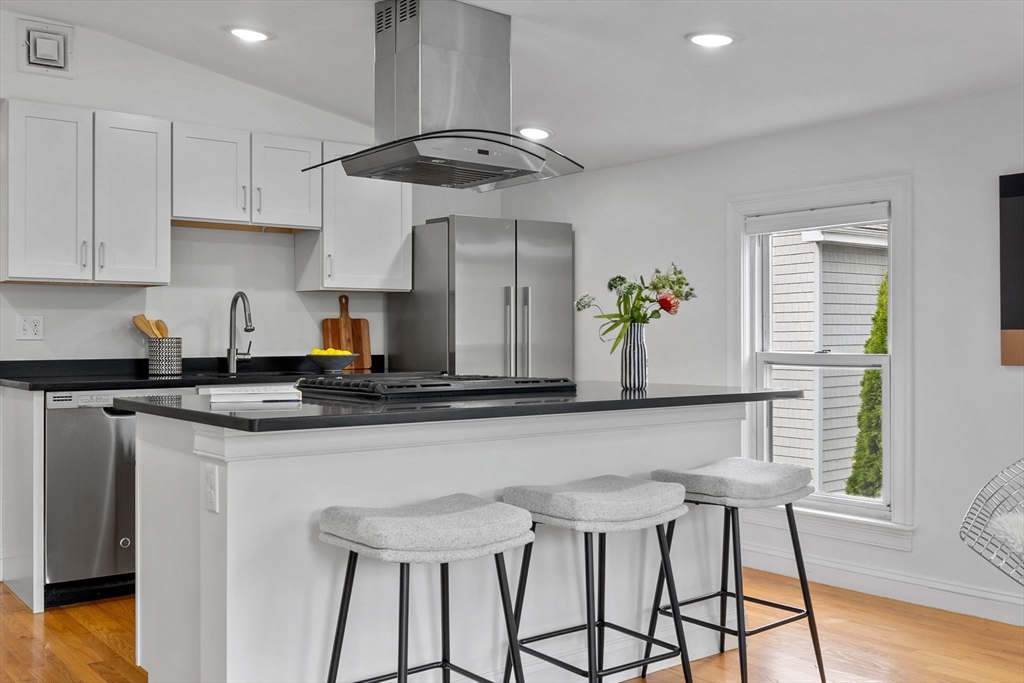 25 Clark Street, Unit 2 Somerville, MA 02143 - Photo 4 of 20 a kitchen with stainless steel appliances a sink a table and chairs in it