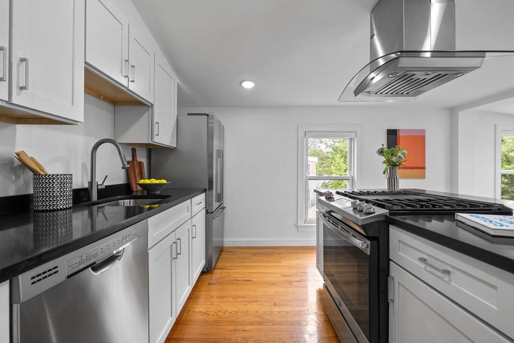 25 Clark Street, Unit 2 Somerville, MA 02143 - Photo 5 of 20 a kitchen with stainless steel appliances granite countertop a sink stove and cabinets