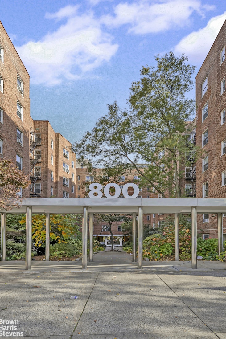 800 Grand Concourse, Unit 6CS Bronx, NY 10451 - Photo 6 of 14 a front view of a building with glass windows and a yard