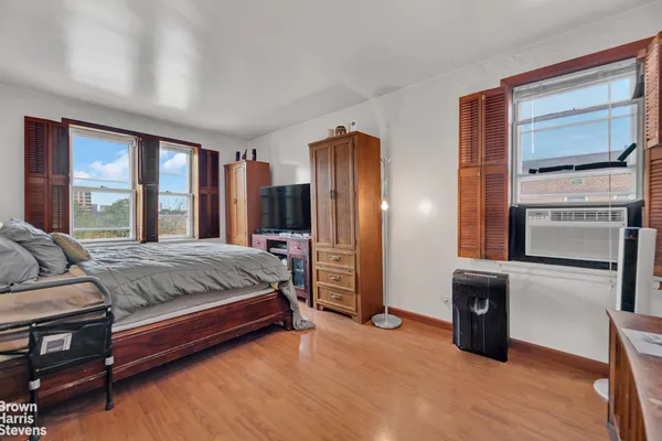 a bedroom with a bed and a television
