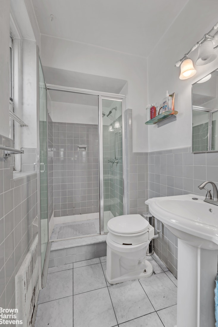 800 Grand Concourse, Unit 6CS Bronx, NY 10451 - Photo 9 of 14 a bathroom with a sink a toilet and shower