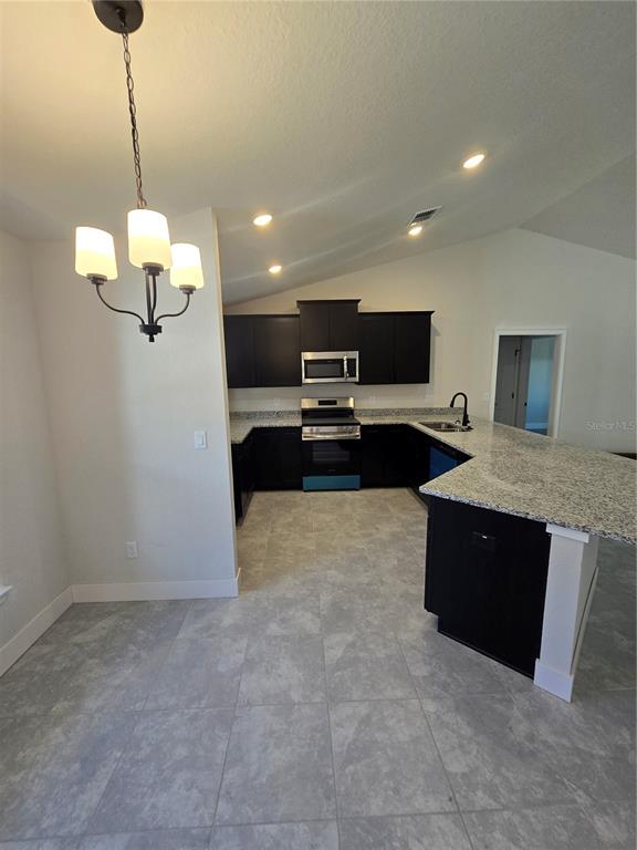 2605 Clearwood Street Inverness, FL 34452 - Photo 11 of 21 a living room with furniture and a chandelier