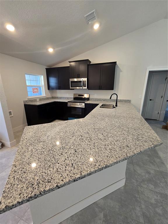 2605 Clearwood Street Inverness, FL 34452 - Photo 12 of 21 a kitchen with kitchen island sink and faucet