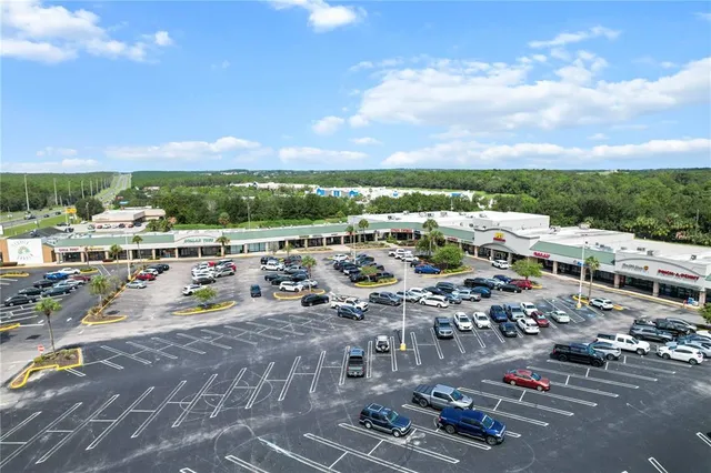 an aerial view of residential houses with outdoor space and street view