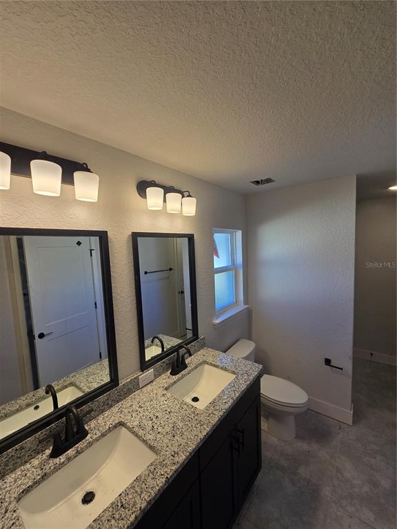 2605 Clearwood Street Inverness, FL 34452 - Photo 18 of 21 a bathroom with a granite countertop sink and a mirror