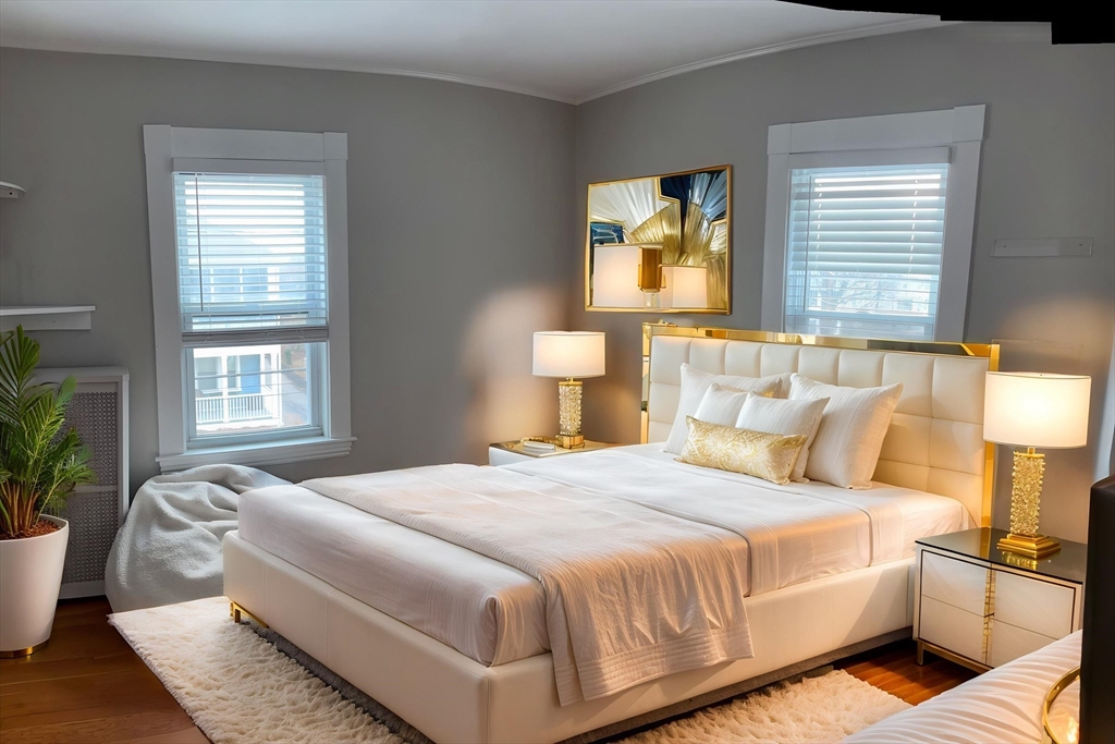 a bedroom with a large bed and a potted plant