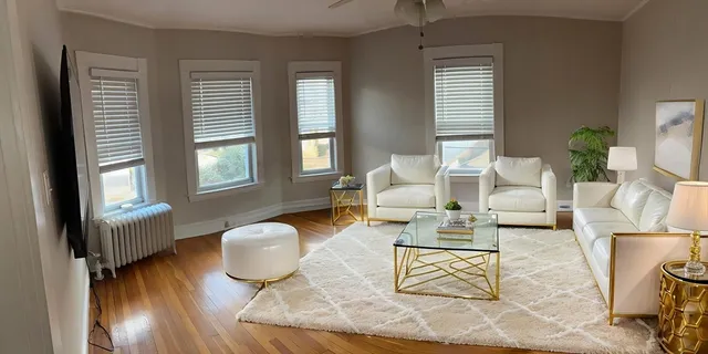 a living room with furniture rug and window