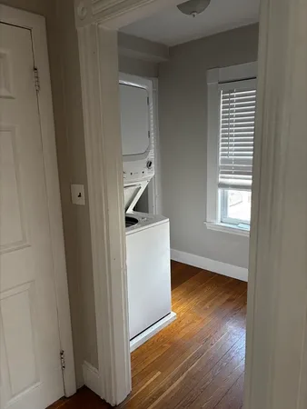 a view of an empty room and wooden floor