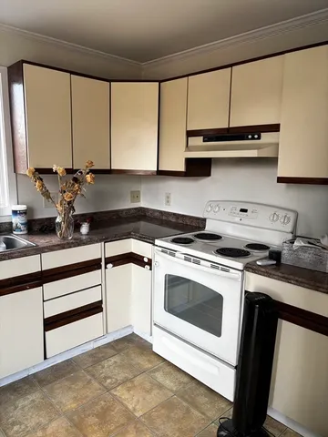 a kitchen with stainless steel appliances granite countertop a sink a stove and a microwave